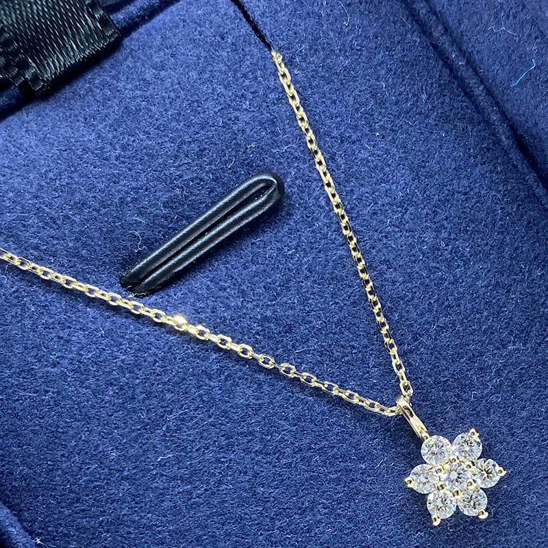 Gold flower pendant necklace set with round lab-grown diamonds