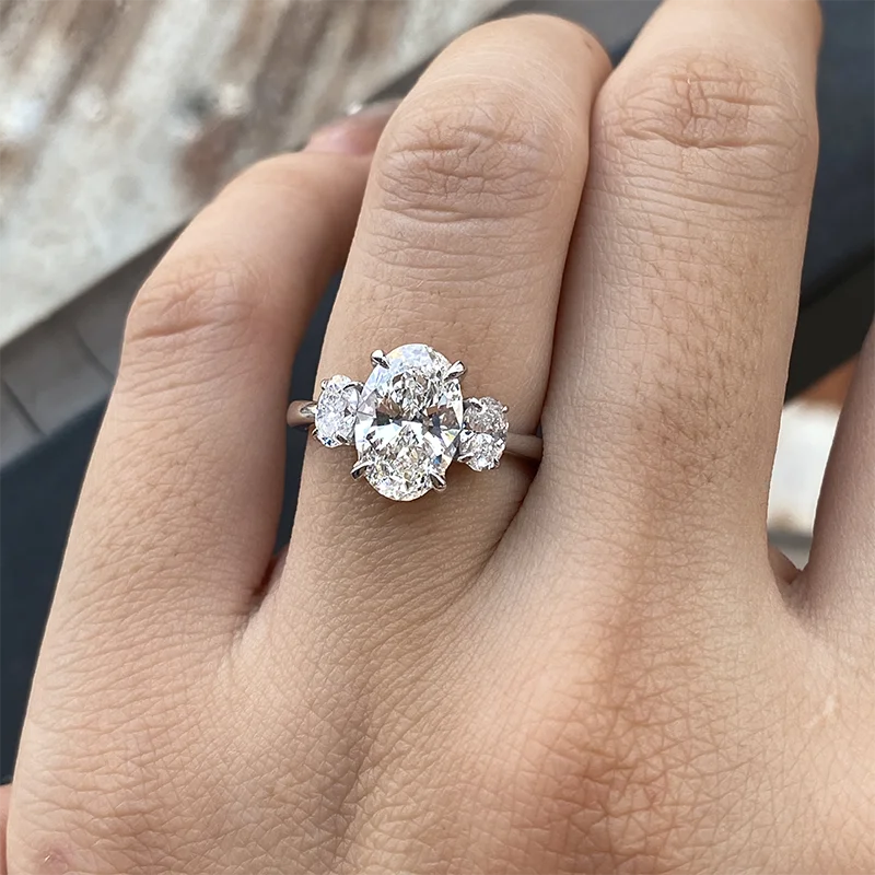 Gold oval diamond ring with oval side stones