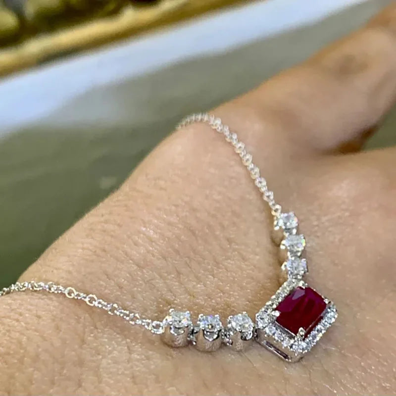 Ruby and diamond halo pendant necklace