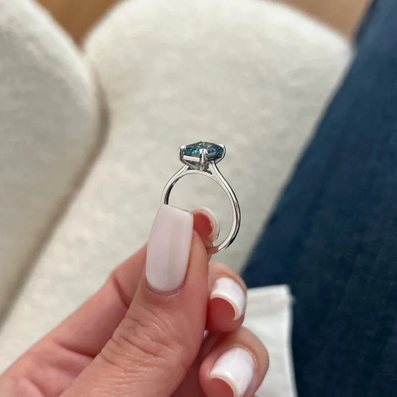 Gold ring with blue emerald-cut diamond