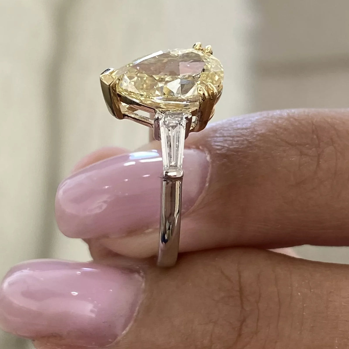 Yellow pear diamond engagement ring with side stones