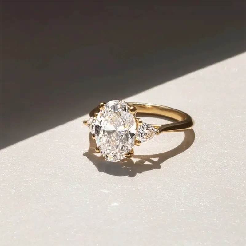 Oval lab-grown diamond ring accented by two pear-cut diamonds