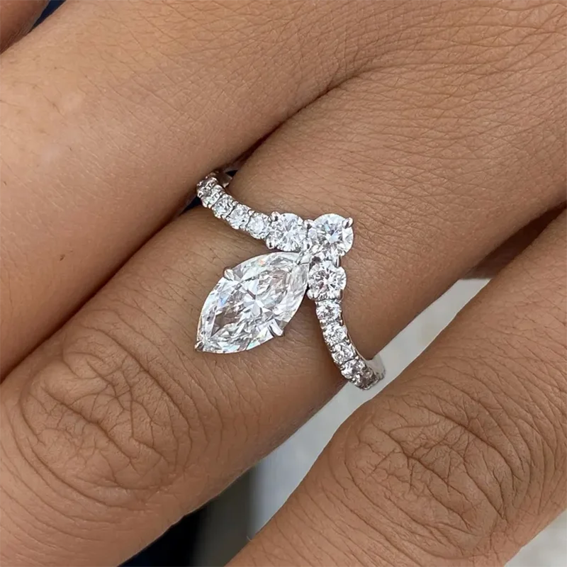 Gold marquise diamond ring with round accents