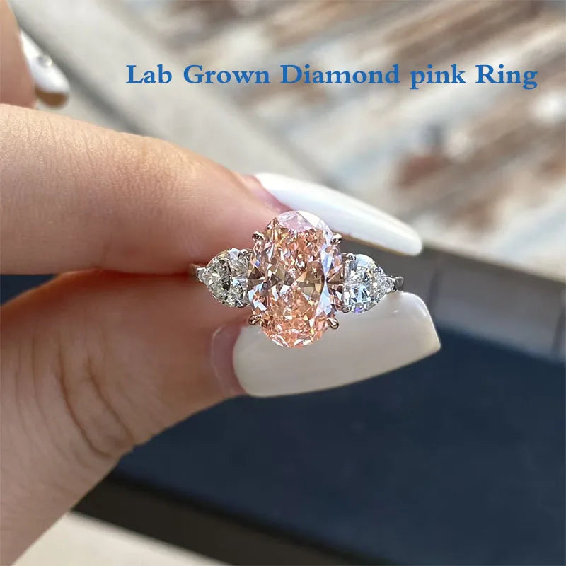 Pink oval lab-grown diamond ring with heart-shaped side stones