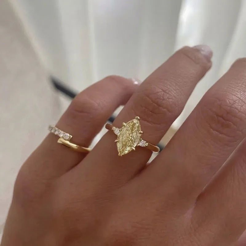 Yellow marquise diamond ring with side stones