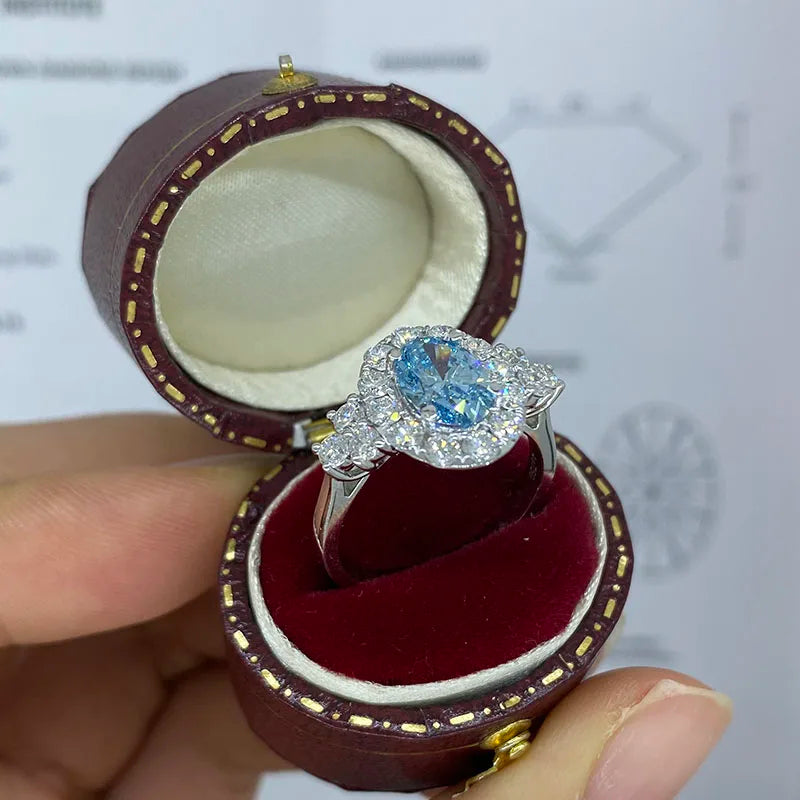 Gold ring featuring blue oval lab-grown diamond
