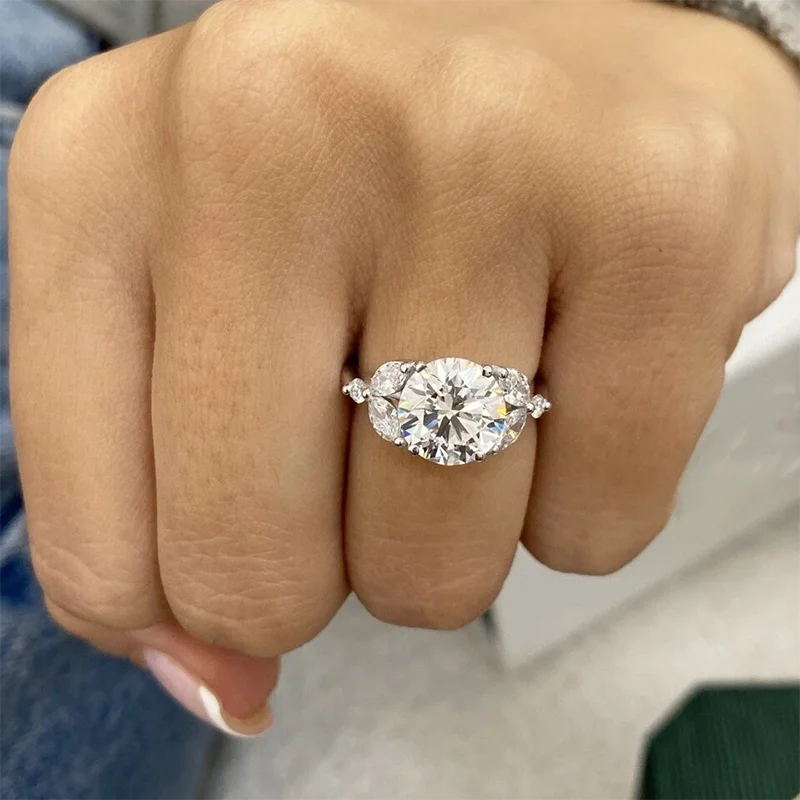Round-cut diamond engagement ring with cluster accents