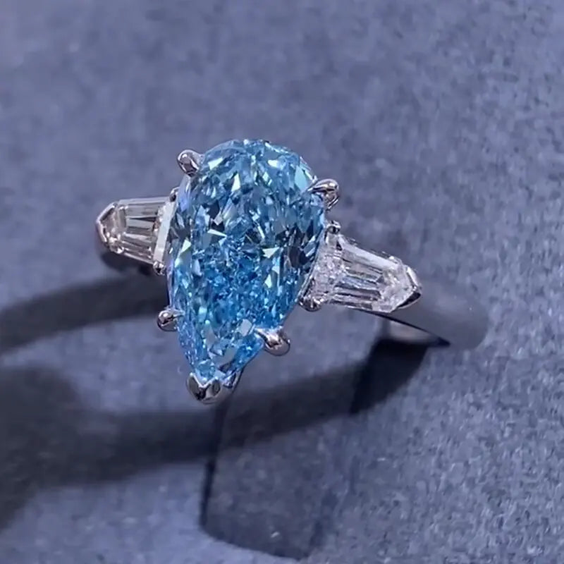 Pear-shaped blue diamond ring with accent stones