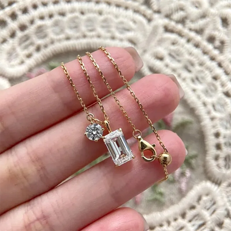 Emerald-cut diamond pendant with round accent