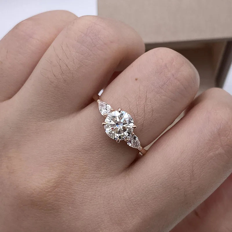 Round lab-grown diamond three-stone ring with pear side stones