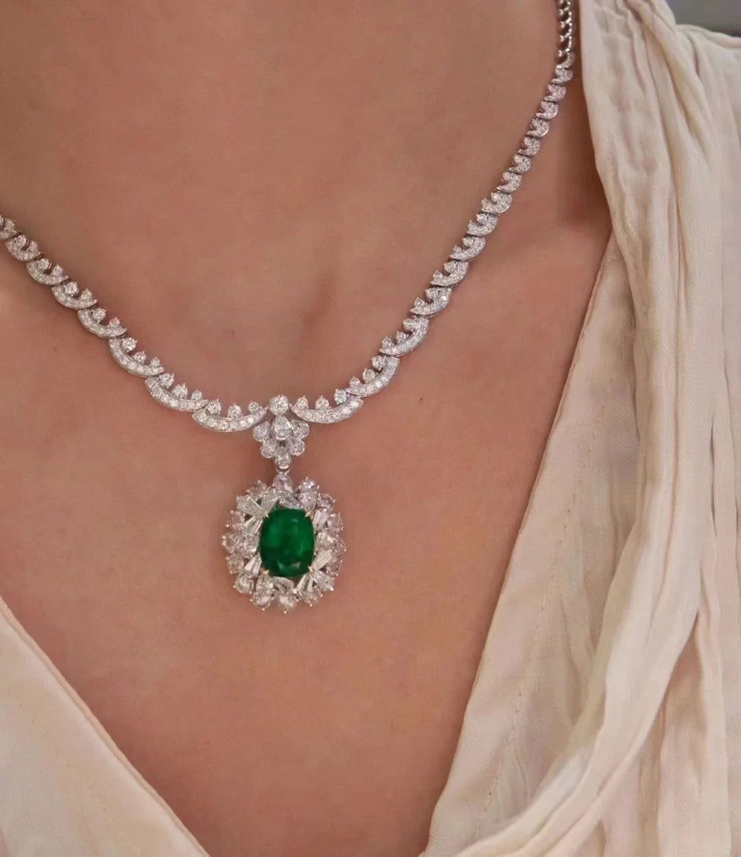 Oval lab emerald pendant necklace with diamond accents