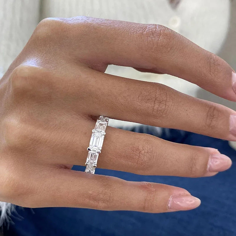 Five emerald-cut lab-grown diamonds on ring band