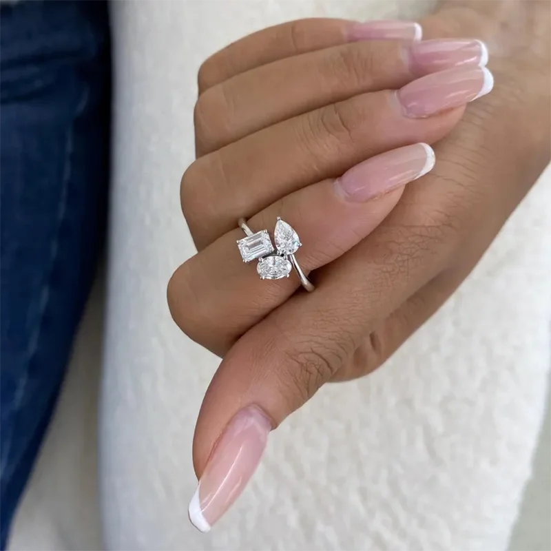 Lab-grown diamond ring with emerald pear and oval stones