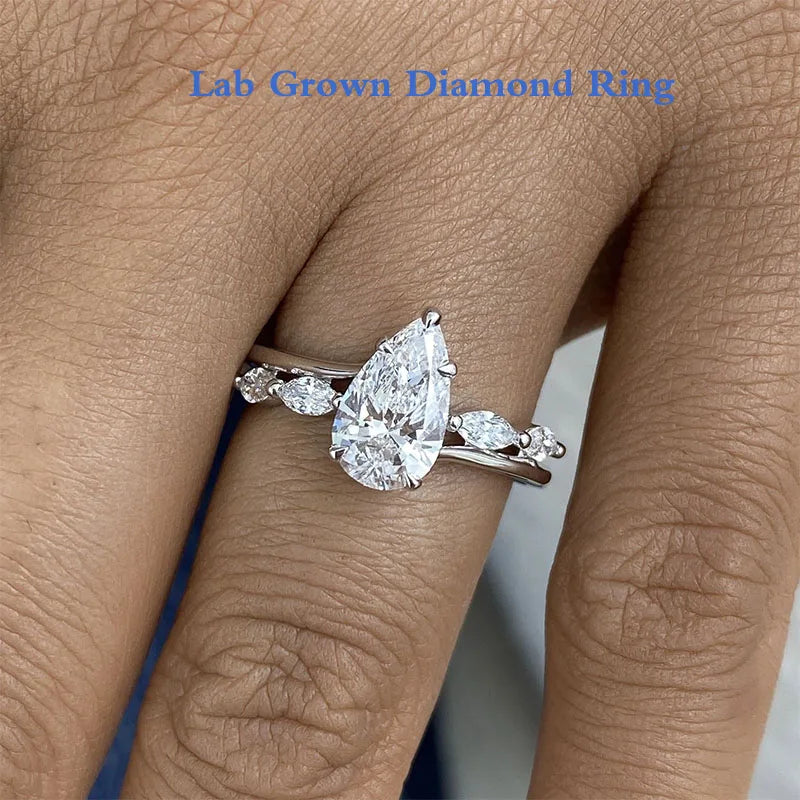 Lab-grown diamond ring with pear-cut center and marquise accents