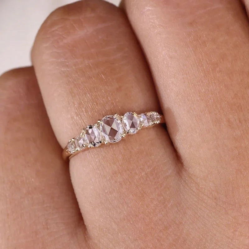 Gold ring with mixed oval and round diamonds