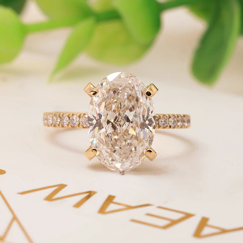 Gold oval lab-grown diamond engagement ring with pavé accents
