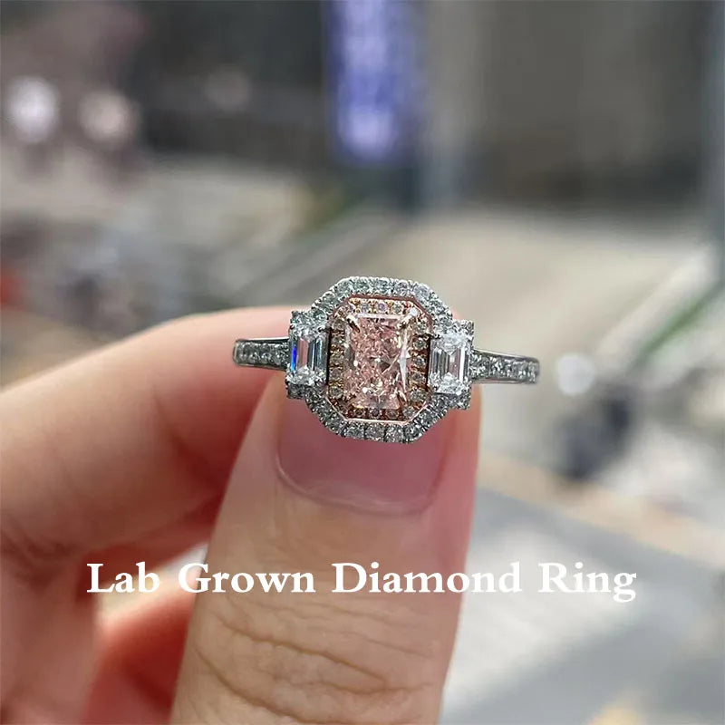 Fancy pink diamond ring with emerald and round accents
