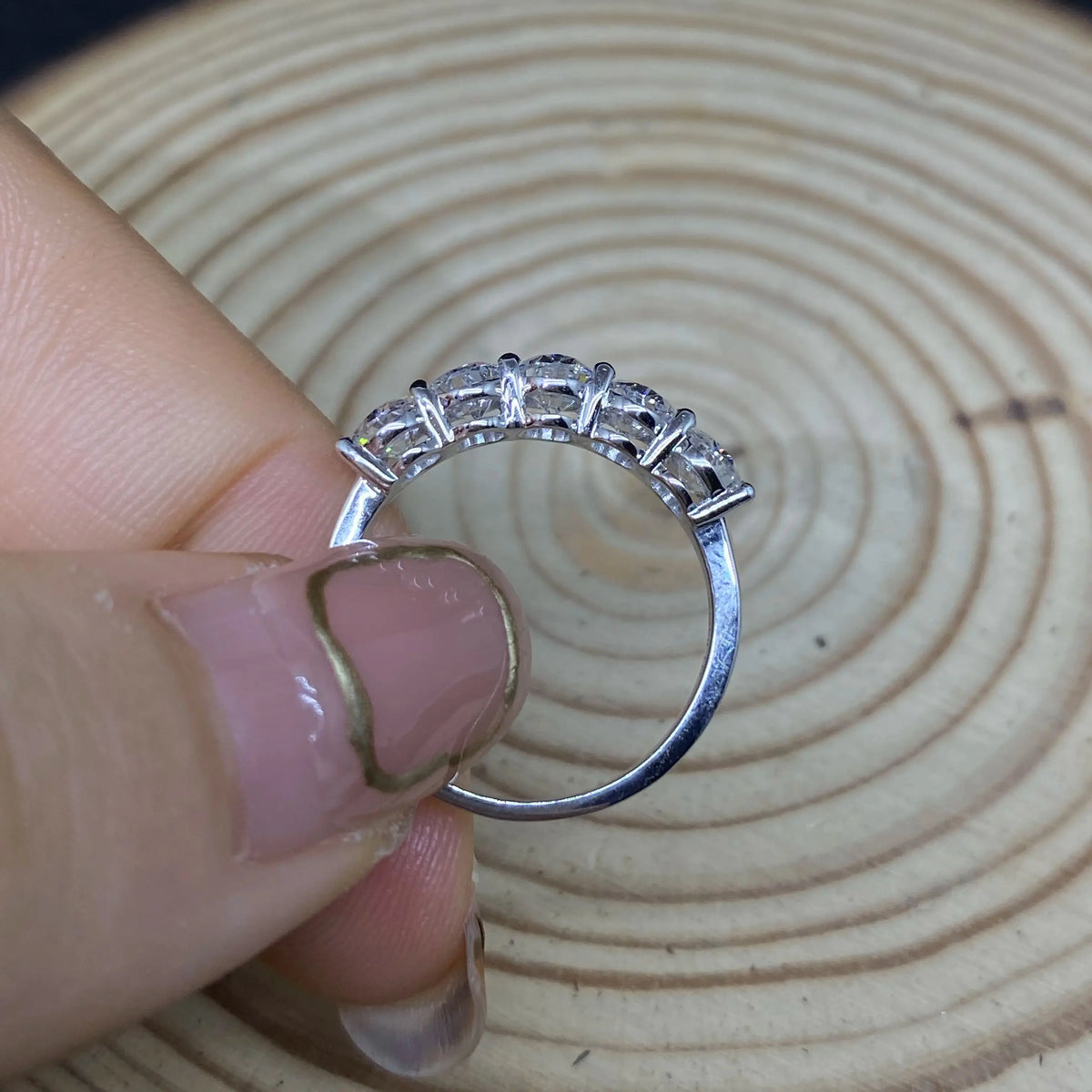 Five oval-cut lab-grown diamonds across a ring band