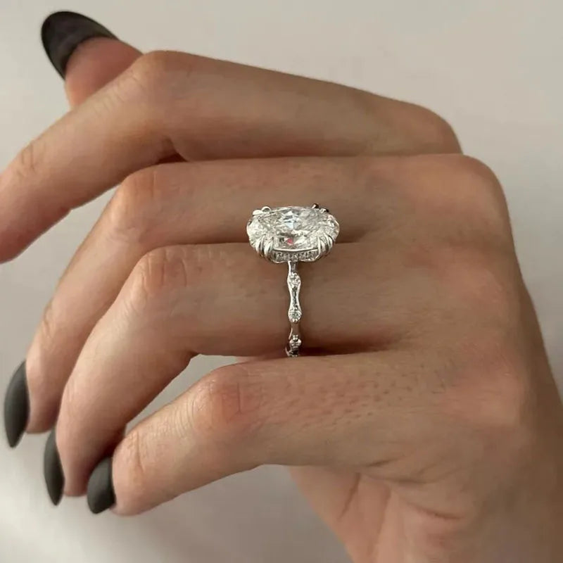 Gold oval diamond engagement ring with double claw prongs