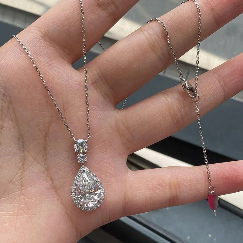 Pear diamond necklace with round accent stones