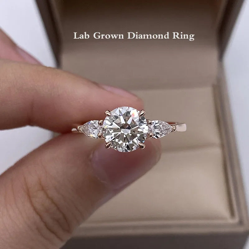 Gold engagement ring with round center diamond and pear accents