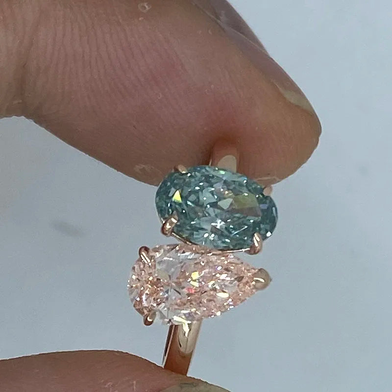 Two-stone pink pear and green oval diamond ring