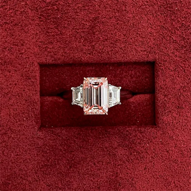 Pink lab-grown diamond and side stone engagement ring