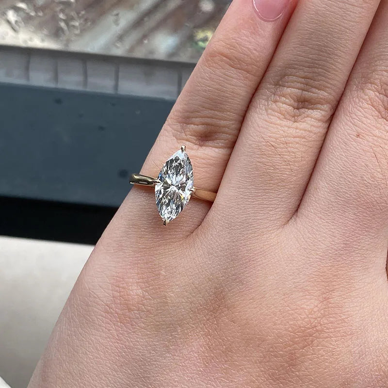Gold engagement ring featuring a marquise lab-grown diamond