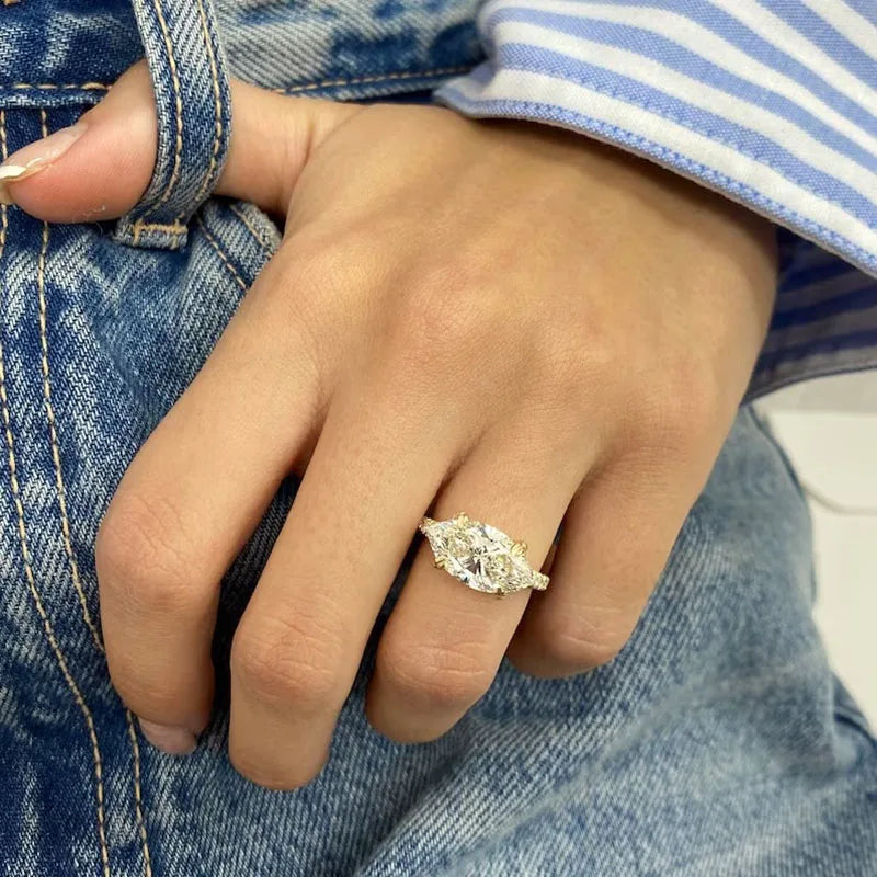 Gold marquise diamond ring with round accents
