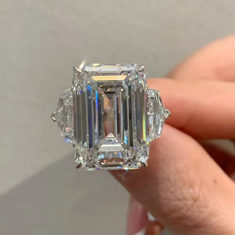 Three-stone ring with emerald-cut diamond