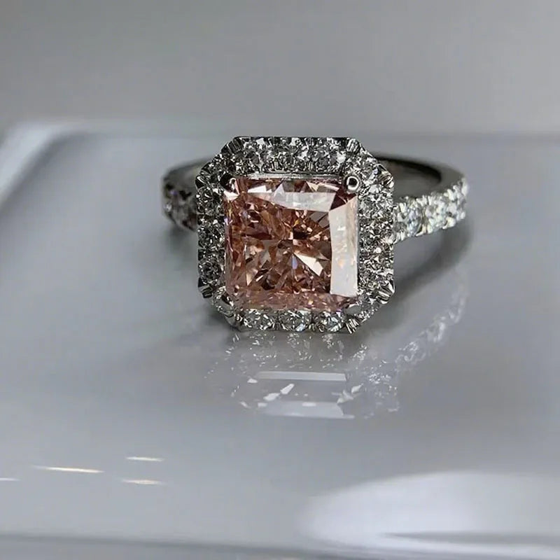 Pink cushion diamond ring with halo accents