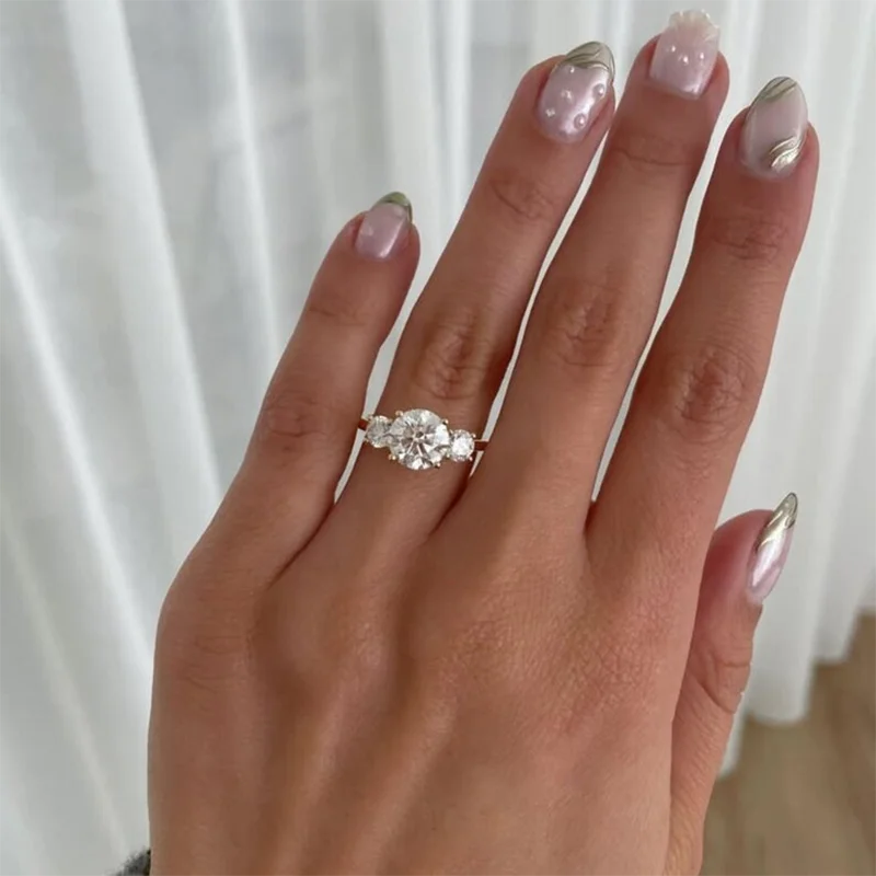 Three round lab-grown diamond ring with prominent center stone