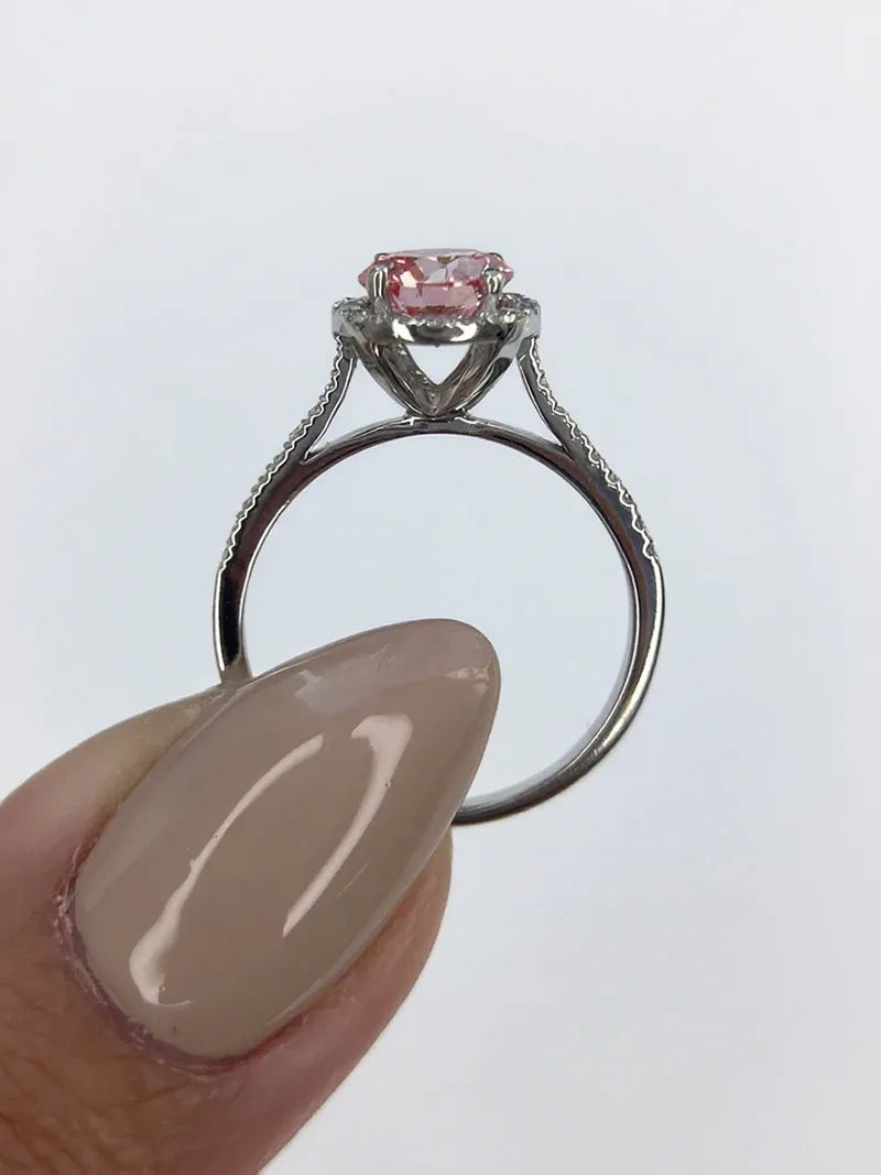 Pink round-cut diamond engagement ring with accent stones