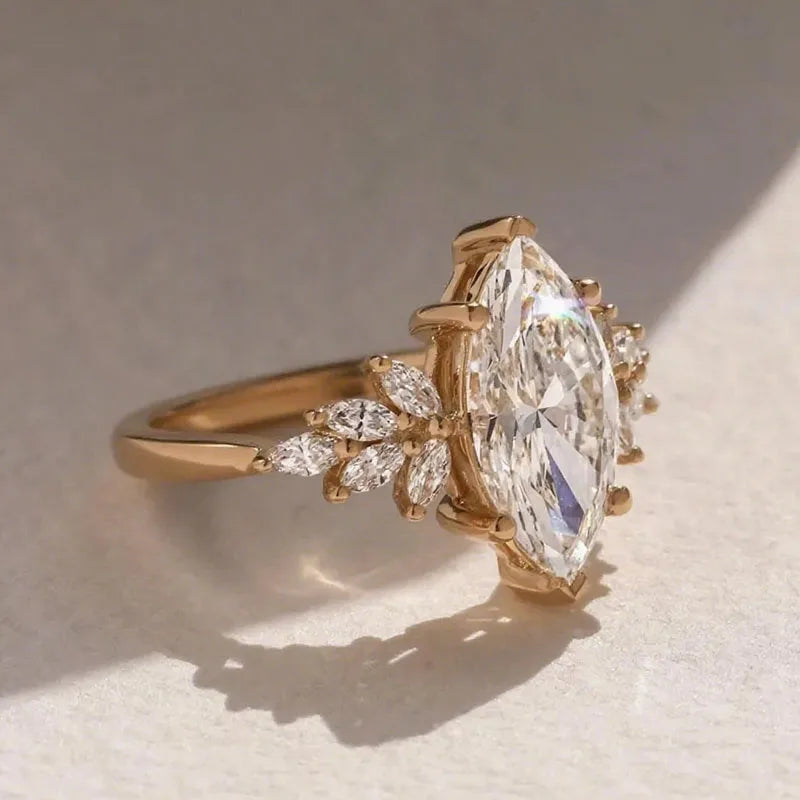 Gold marquise diamond ring with diamond accents