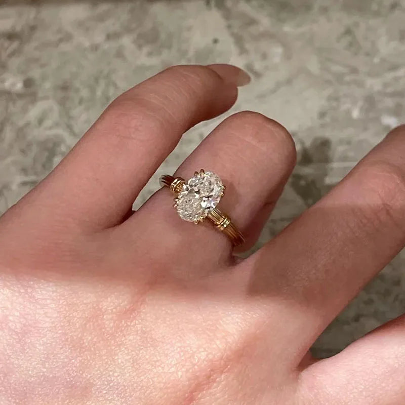 Oval diamond ring with architectural band details