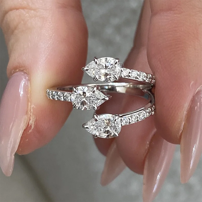 Gold wrap ring with pear and round lab-grown diamonds