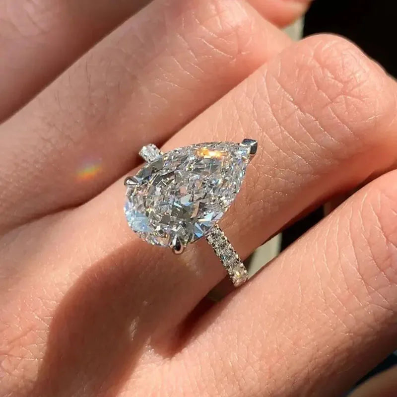 Gold hidden-halo engagement ring with pear diamond