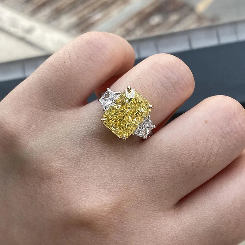 Two-tone gold ring with yellow radiant diamond and two side stones