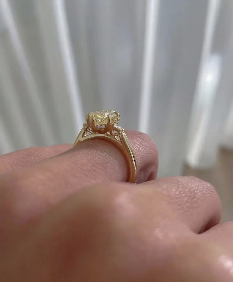 Three-stone diamond ring with yellow marquise center