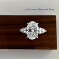 Oval lab-grown diamond three-stone ring with pear accents