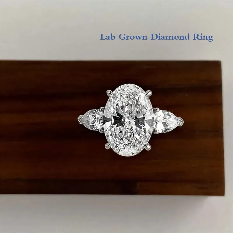 Oval lab-grown diamond three-stone ring with pear accents