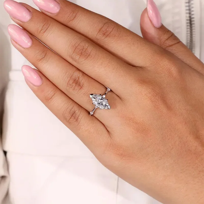 Gold marquise diamond engagement ring with small round diamonds
