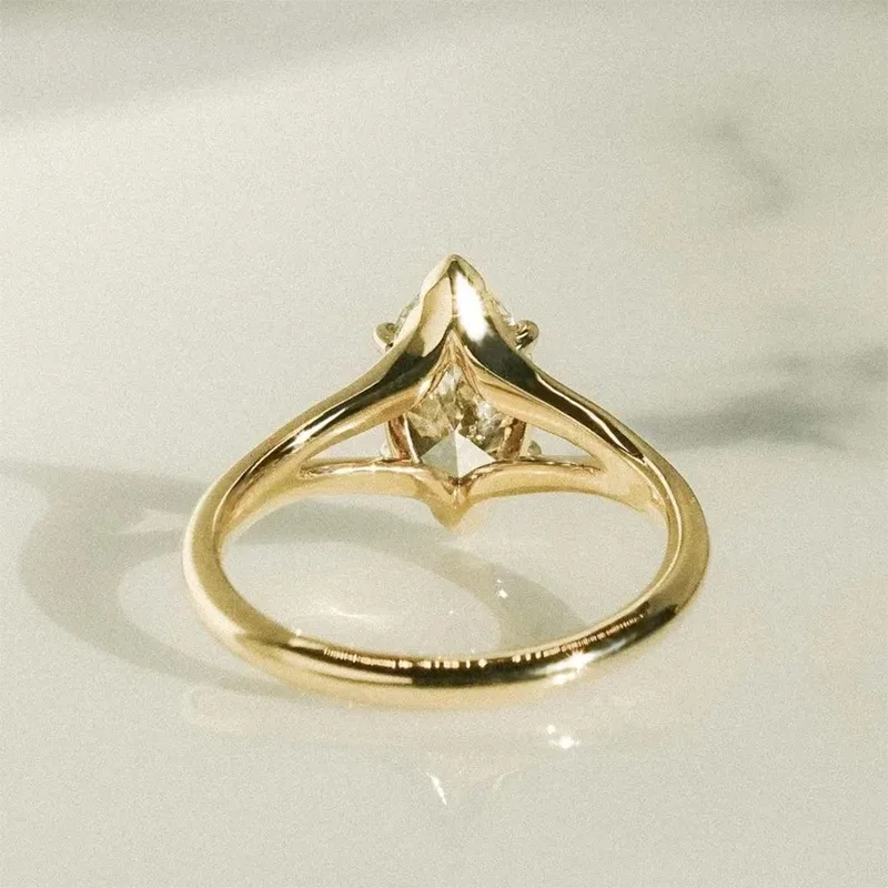 Gold marquise diamond engagement ring with split shank