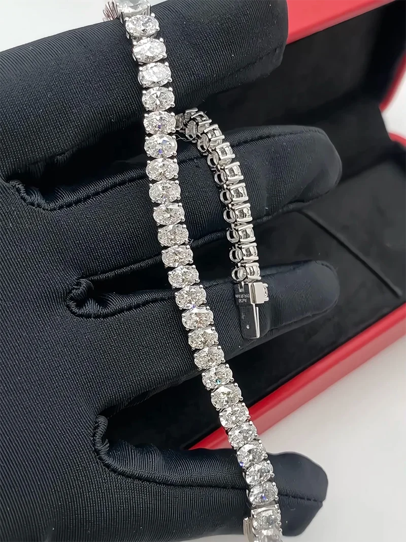 Gold tennis bracelet featuring a continuous line of oval lab-grown diamonds