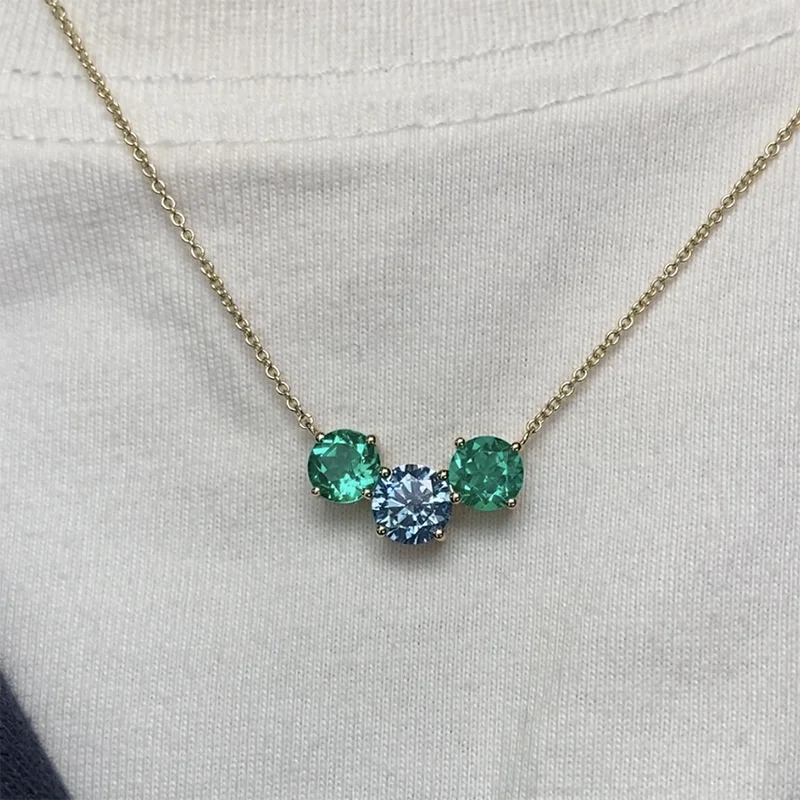 Three-stone blue and emerald diamond necklace