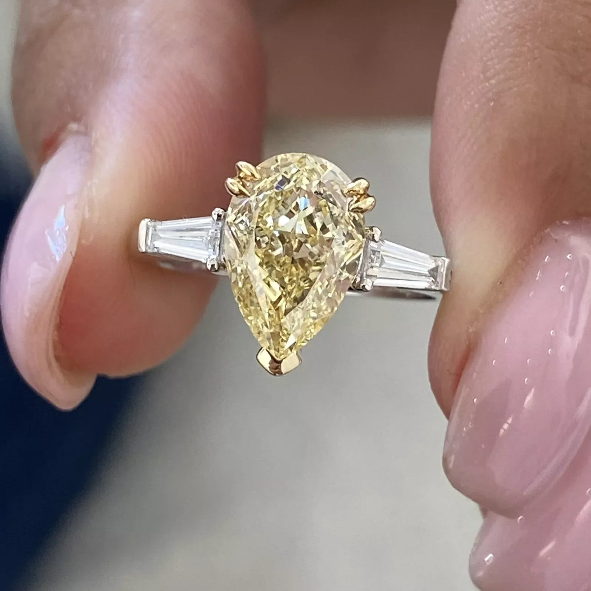 Two-tone gold ring with yellow pear-shaped diamond