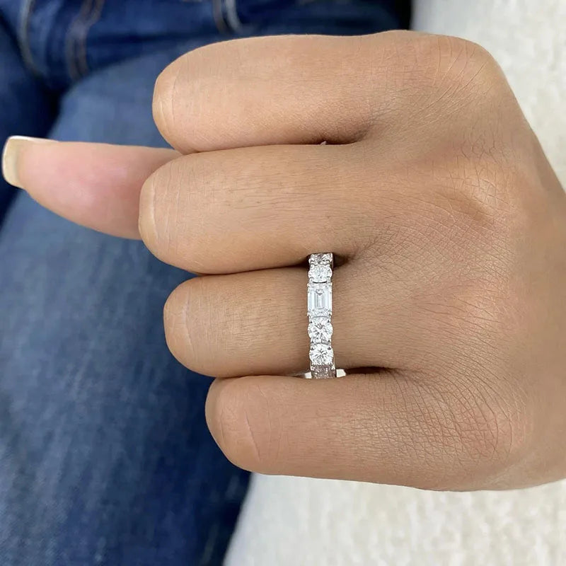 Gold diamond ring featuring emerald and round-cut stones