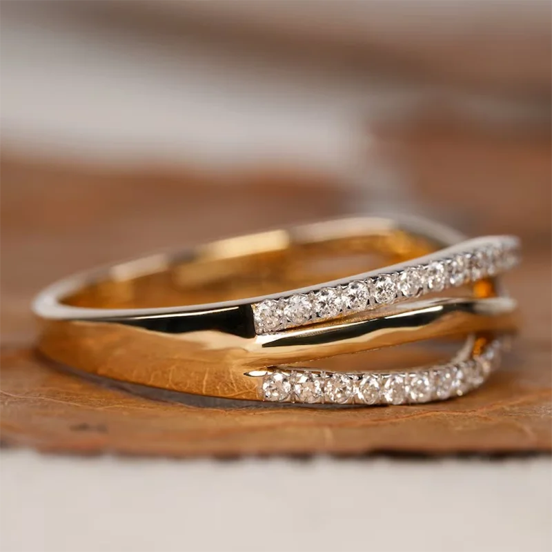 Two-tone gold diamond crossover ring