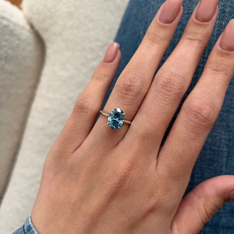 Gold engagement ring with blue oval lab-grown diamond