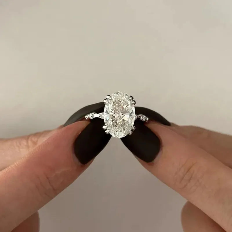 Nature-inspired oval diamond ring with round accents